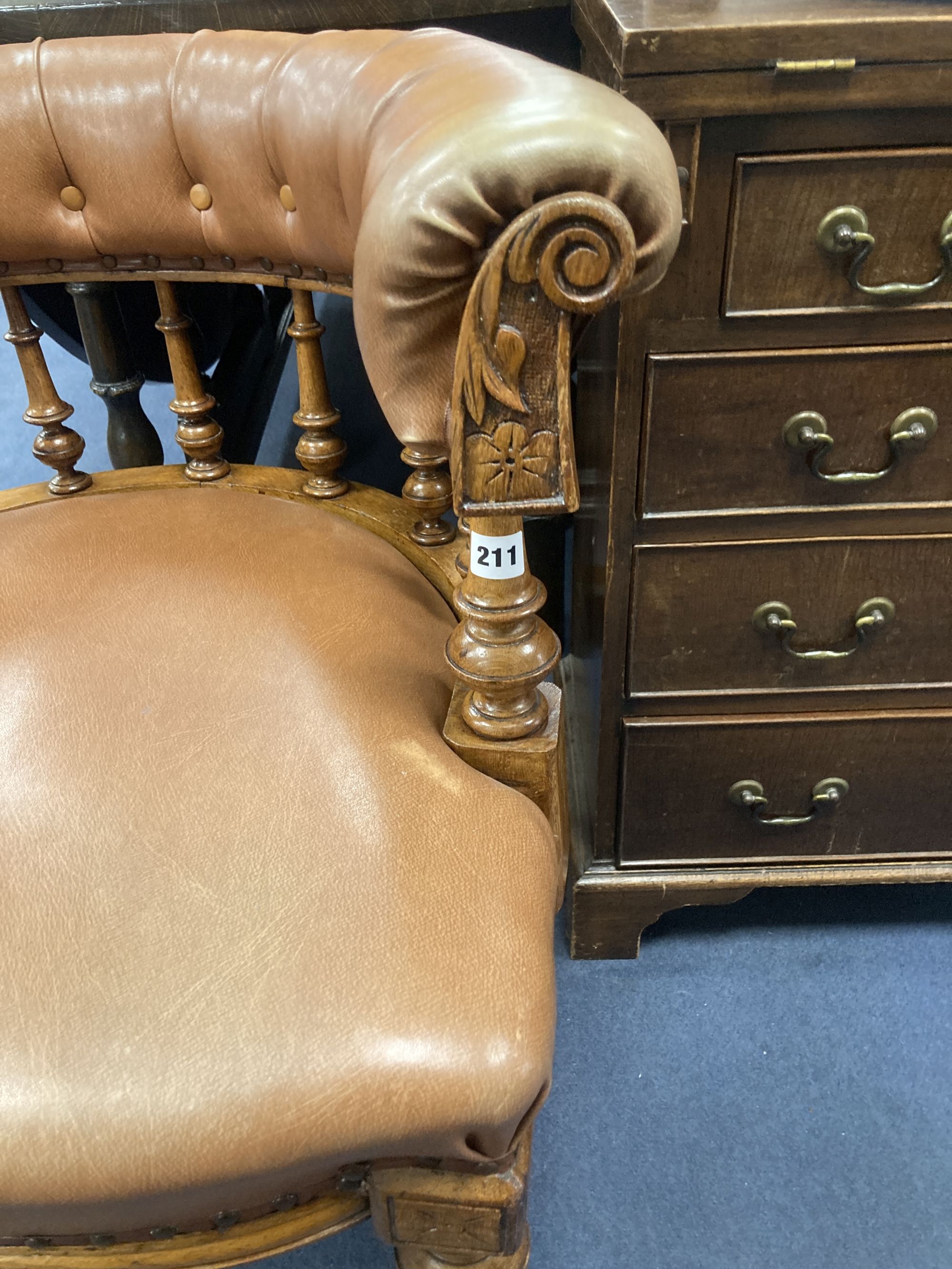 A Victorian oak tub framed library chair, upholstered in brown leather, width 60cm, depth 60cm, height 74cm